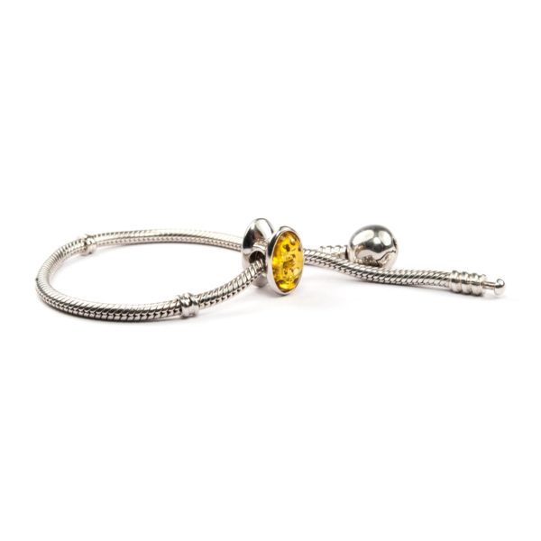 Pandora style bead with yellow amber on bracelet