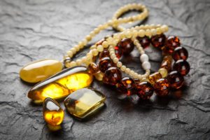 amber bracelet and pendant on dark background